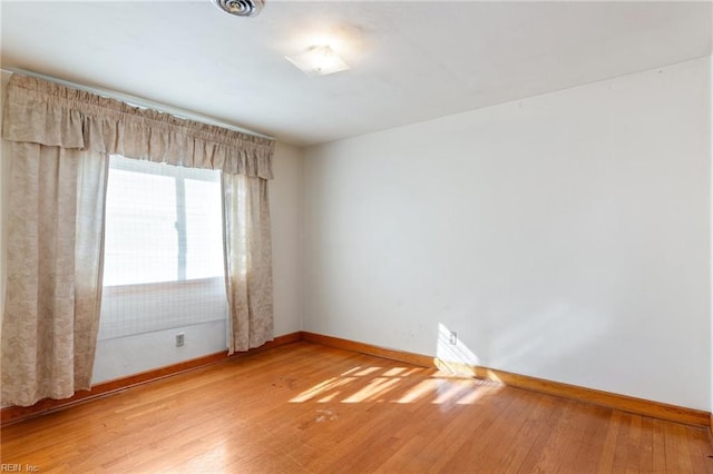 unfurnished room with wood-type flooring