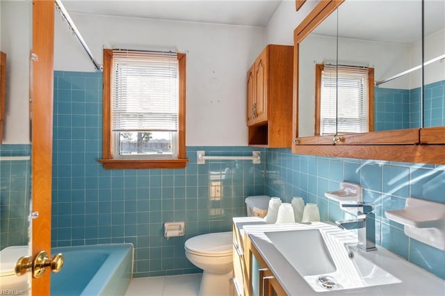 full bathroom featuring a healthy amount of sunlight, toilet, tub / shower combination, and vanity