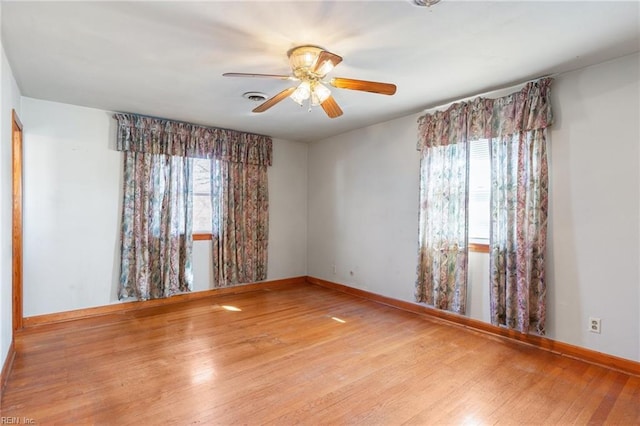 empty room featuring light hardwood / wood-style flooring and ceiling fan