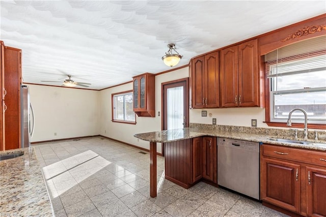 kitchen featuring light stone counters, ornamental molding, stainless steel appliances, and sink