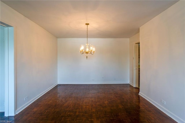 unfurnished dining area featuring an inviting chandelier and dark parquet flooring