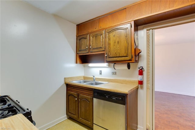 kitchen with dishwasher, sink, and black gas range