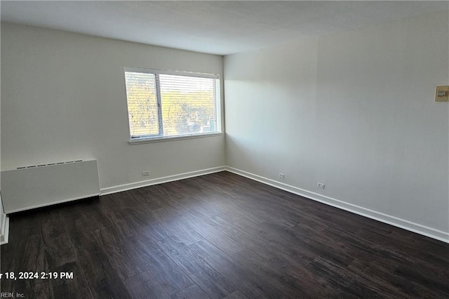 unfurnished room featuring dark hardwood / wood-style floors