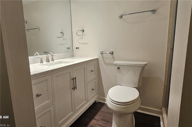 bathroom with wood-type flooring, toilet, and vanity