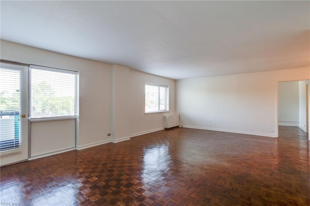 spare room with dark parquet flooring