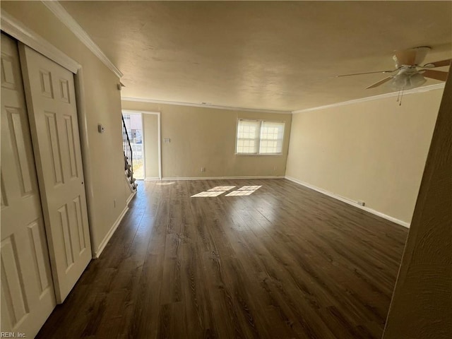 spare room with ornamental molding, dark wood-type flooring, and ceiling fan