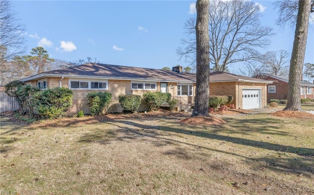 single story home with a garage and a front lawn