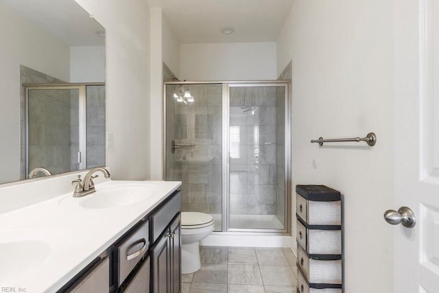 bathroom with vanity, toilet, and an enclosed shower