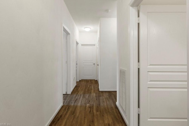 hallway featuring dark hardwood / wood-style flooring