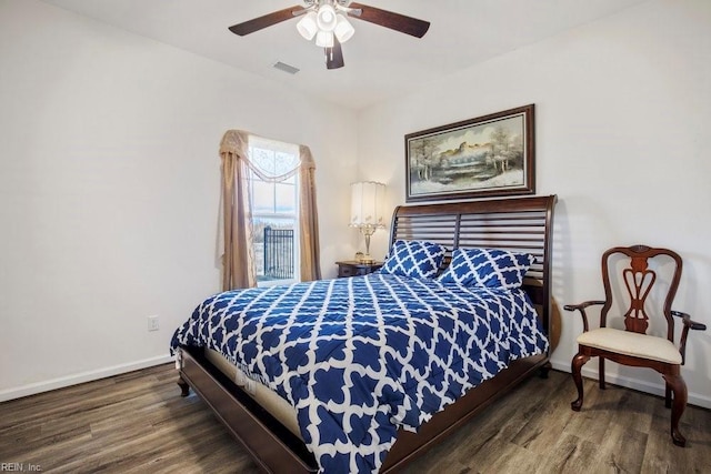 bedroom with dark wood-type flooring and ceiling fan