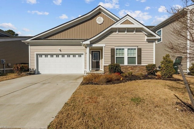 craftsman-style home featuring a garage and a front lawn