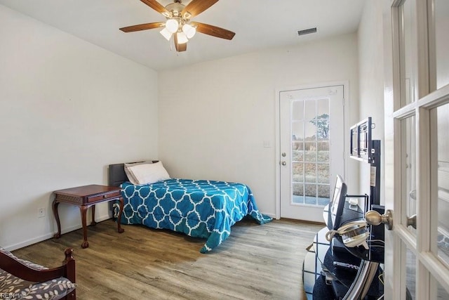 bedroom featuring wood-type flooring, access to outside, and ceiling fan