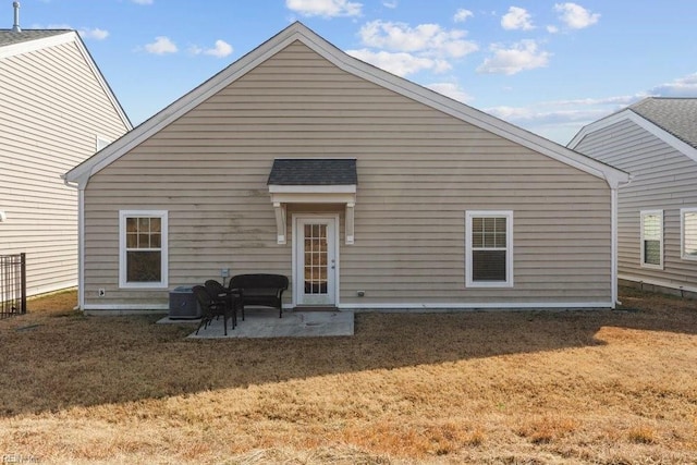 back of property with a patio, cooling unit, and a lawn