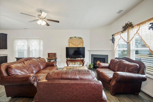 living room with ceiling fan and dark hardwood / wood-style flooring