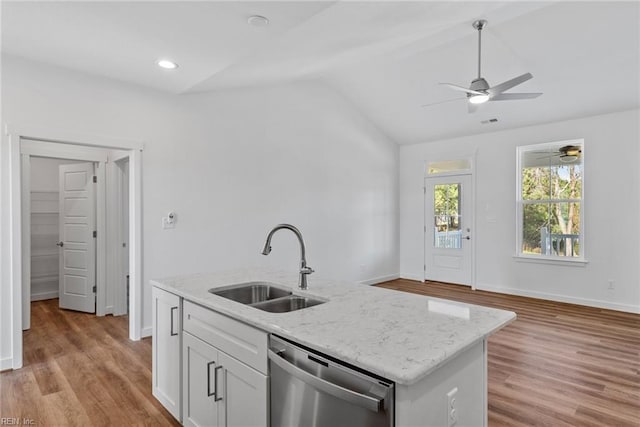 kitchen featuring white cabinetry, dishwasher, sink, an island with sink, and light stone counters