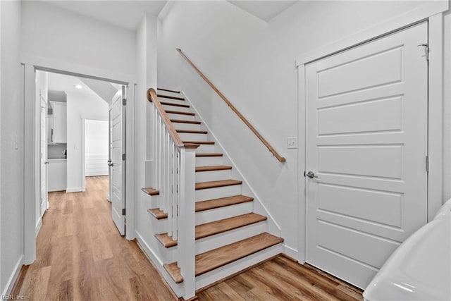 stairs with hardwood / wood-style flooring