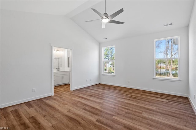 unfurnished bedroom with wood-type flooring, lofted ceiling, ensuite bathroom, and ceiling fan