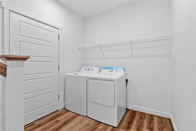 laundry area featuring hardwood / wood-style floors and independent washer and dryer