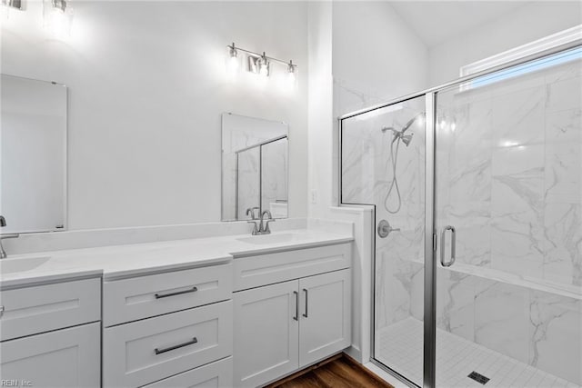 bathroom with vanity, hardwood / wood-style flooring, and a shower with shower door