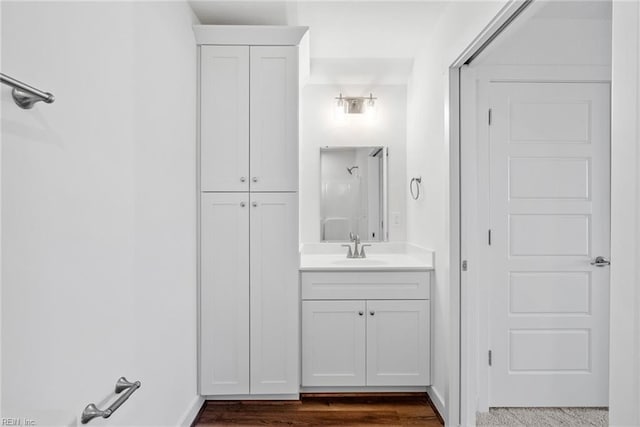 bathroom with vanity, wood-type flooring, and walk in shower