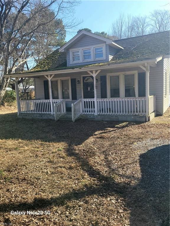 view of front of property featuring a front yard and covered porch