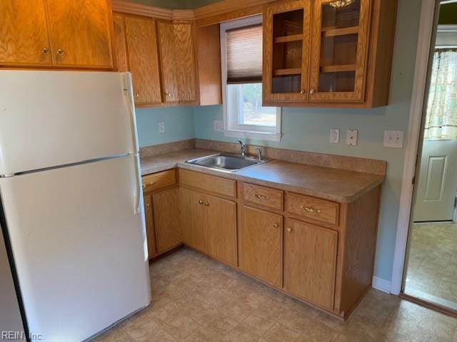 kitchen featuring white fridge and sink