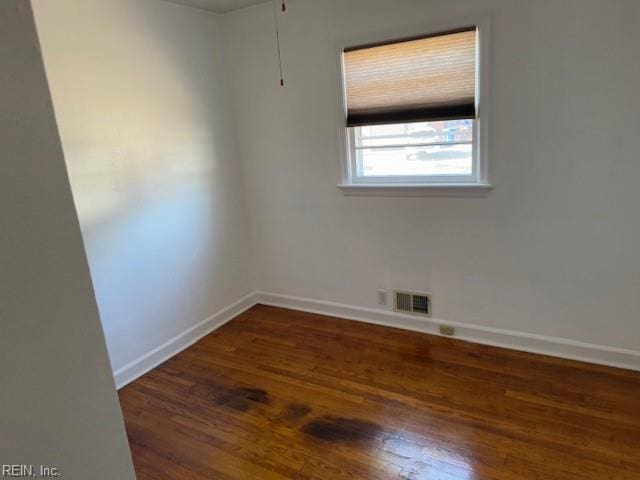 spare room featuring dark hardwood / wood-style flooring