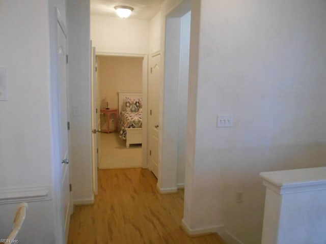 corridor with light wood-type flooring