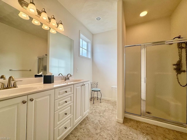 bathroom with walk in shower and vanity