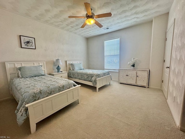 bedroom featuring ceiling fan and light carpet