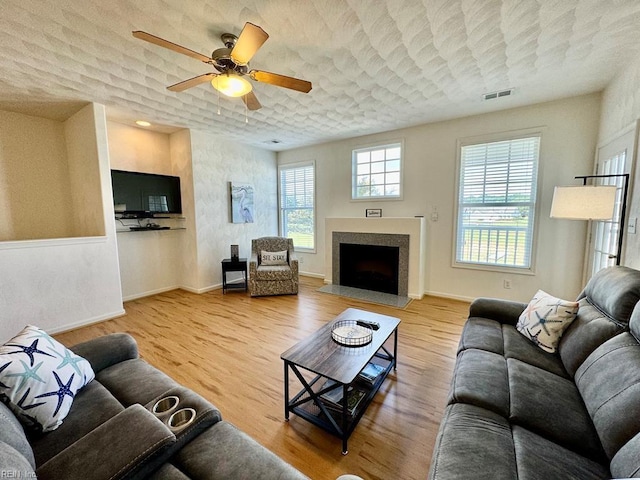 living room with wood-type flooring and ceiling fan