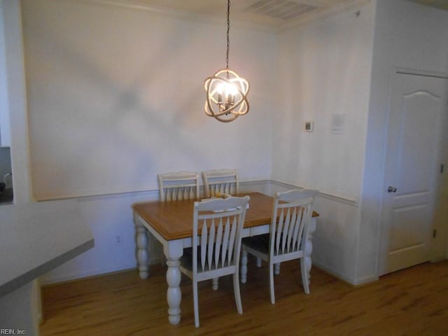 dining room featuring hardwood / wood-style floors and a notable chandelier