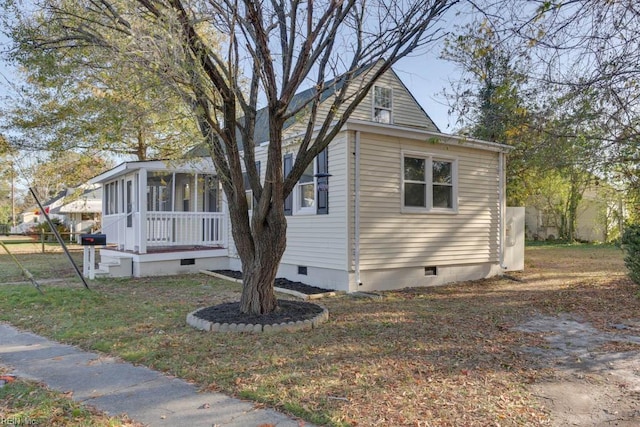 bungalow-style house with a sunroom