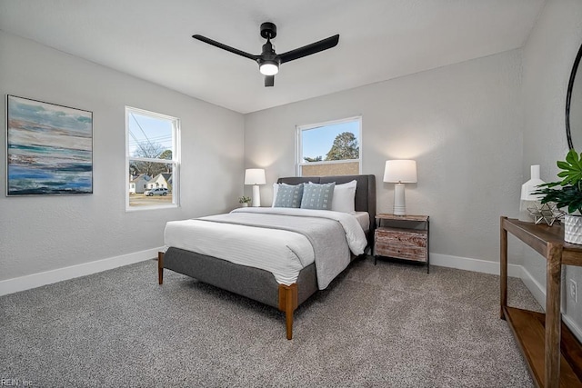 carpeted bedroom with ceiling fan and multiple windows