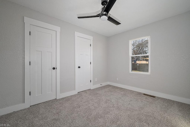 unfurnished bedroom with ceiling fan and carpet