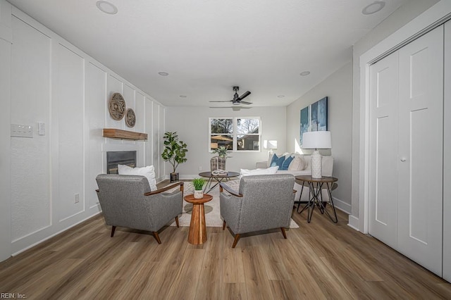 living room featuring hardwood / wood-style floors and ceiling fan