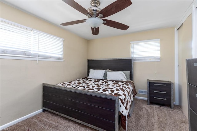 bedroom with ceiling fan, carpet flooring, and a closet