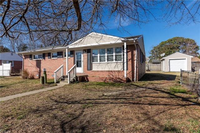 view of front of home featuring an outbuilding, a garage, and a front yard