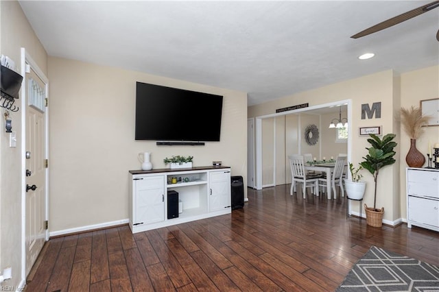 interior space featuring dark hardwood / wood-style flooring and ceiling fan with notable chandelier