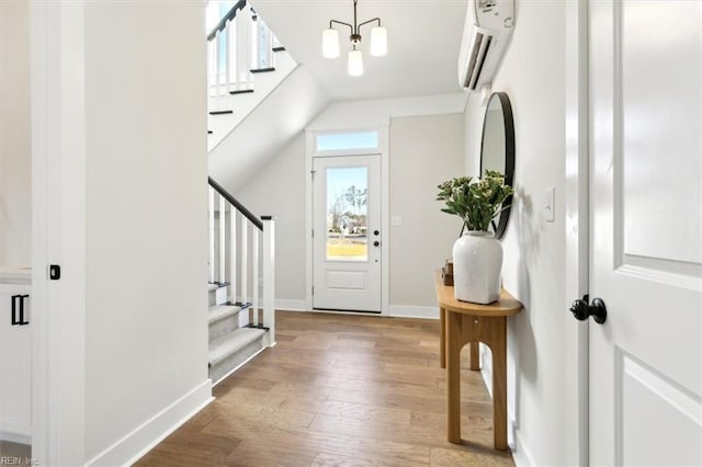 entrance foyer featuring lofted ceiling, a chandelier, and light hardwood / wood-style floors