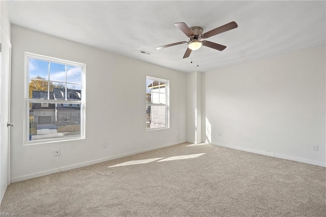 unfurnished room featuring light carpet and ceiling fan