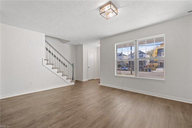 unfurnished living room featuring dark hardwood / wood-style flooring