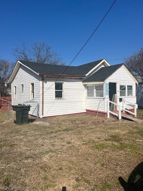 back of house with a yard