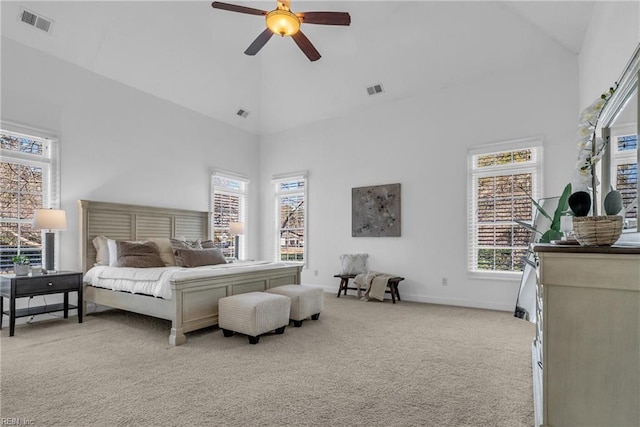 carpeted bedroom featuring multiple windows, ceiling fan, and high vaulted ceiling