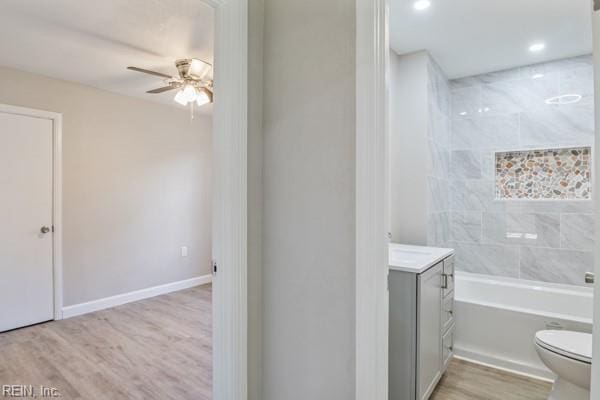 bathroom featuring vanity, hardwood / wood-style floors, ceiling fan, and toilet