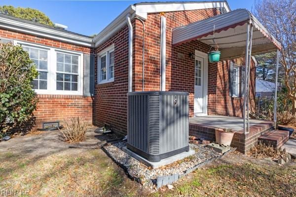 view of side of property with central AC