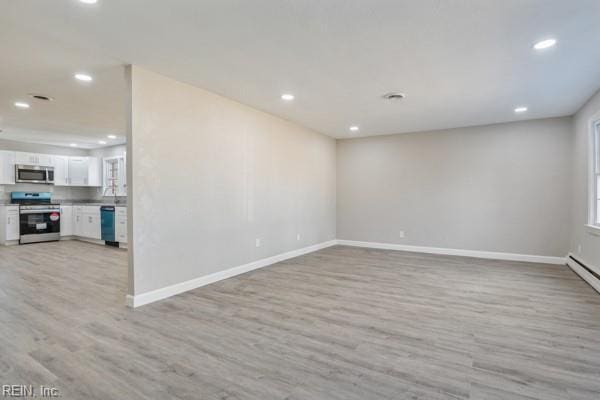 spare room with light hardwood / wood-style flooring