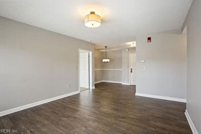 unfurnished room featuring dark hardwood / wood-style floors