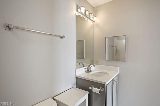 bathroom featuring vanity and toilet