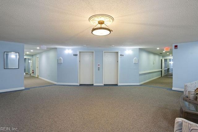 interior space featuring carpet floors and a textured ceiling